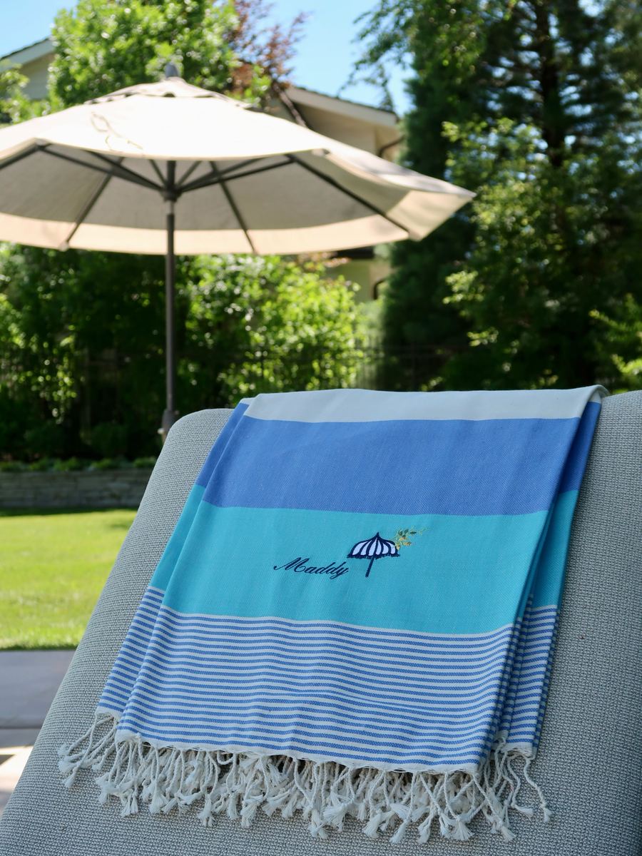 Striped Turkish towel embroidered with an umbrella and olive-branch motif