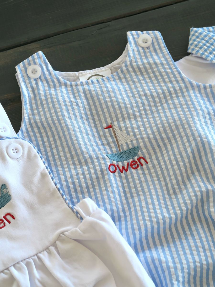 Blue seersucker romper embroidered with the name Owen